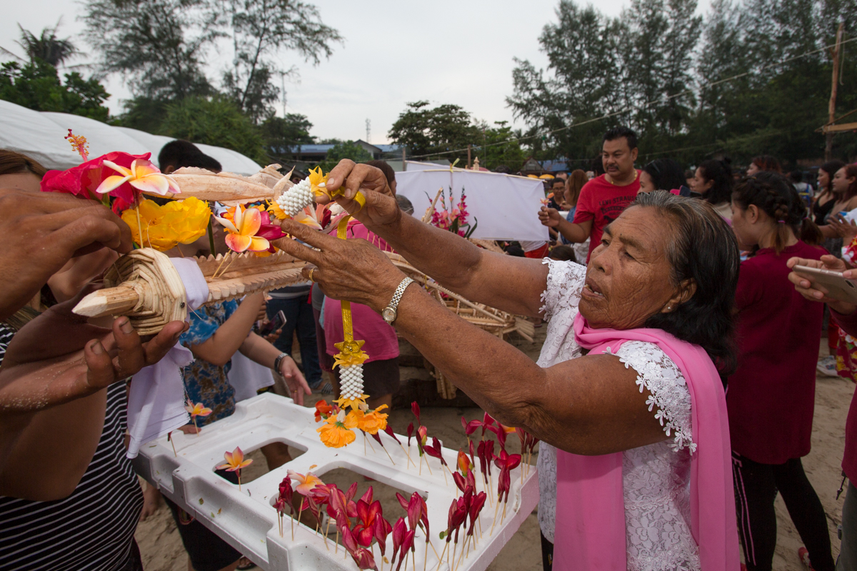 urak lawoi lady placing flowers on the boat